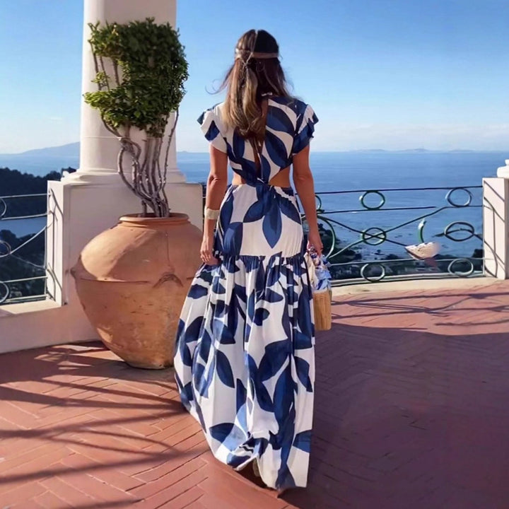 Dam Maxi-klänning med raffinerade cut-out-detaljer och voluminösa volanger Mirla-Eva Jonsson