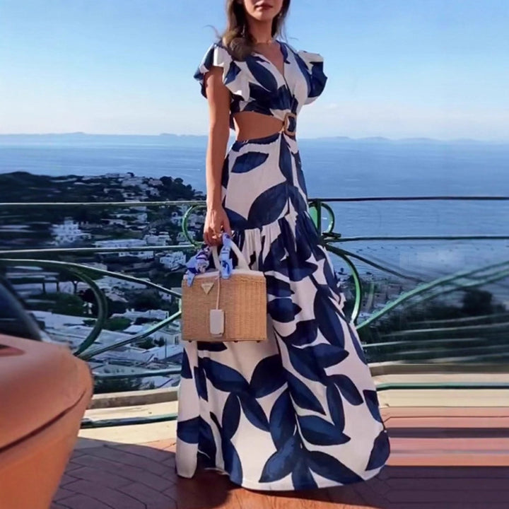 Dam Maxi-klänning med raffinerade cut-out-detaljer och voluminösa volanger Mirla-Eva Jonsson