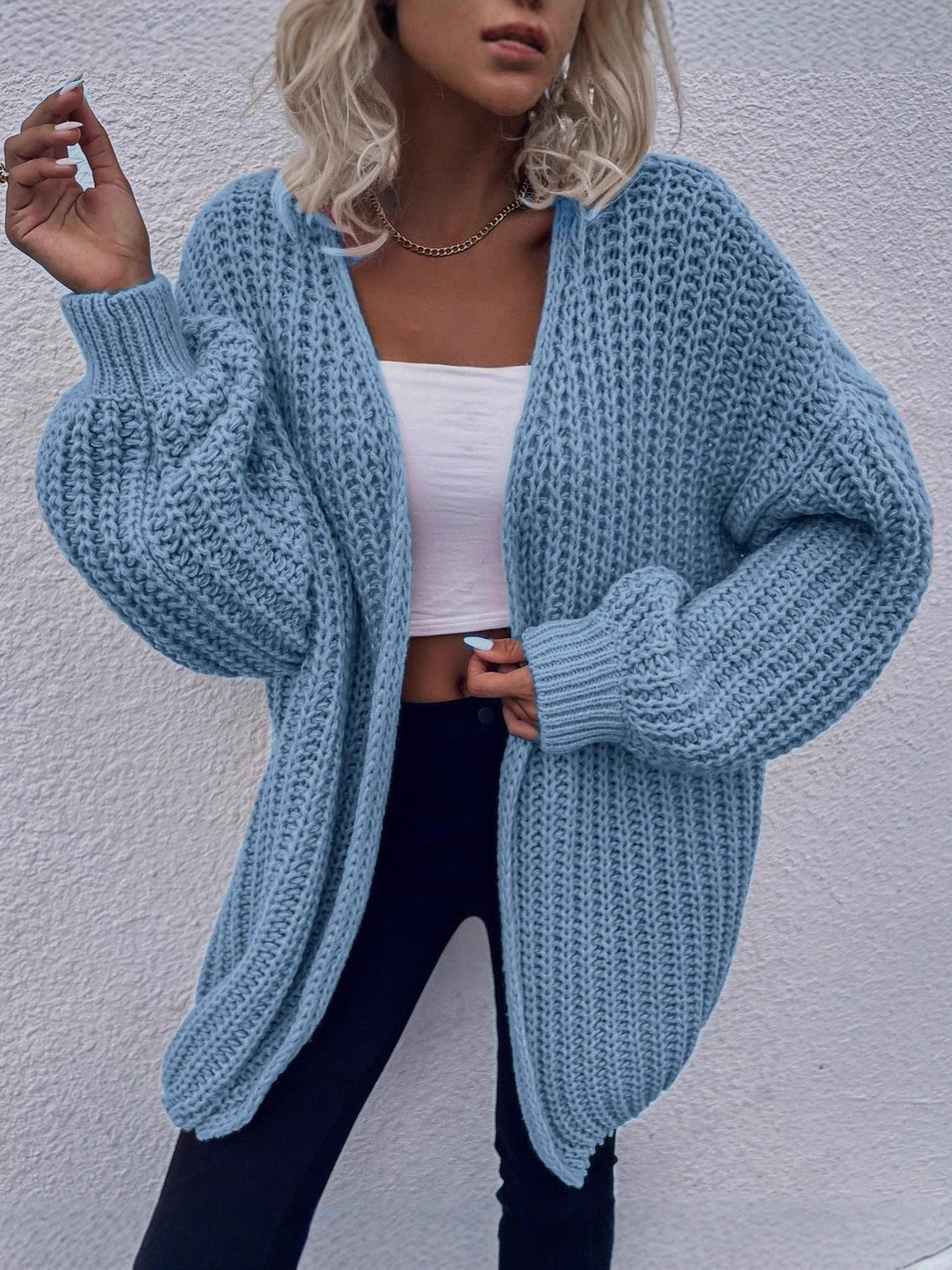 Dam avslappnad grovstickad cardigan med djupa fickor och voluminösa ärmar Eva Jonsson-Eva Jonsson