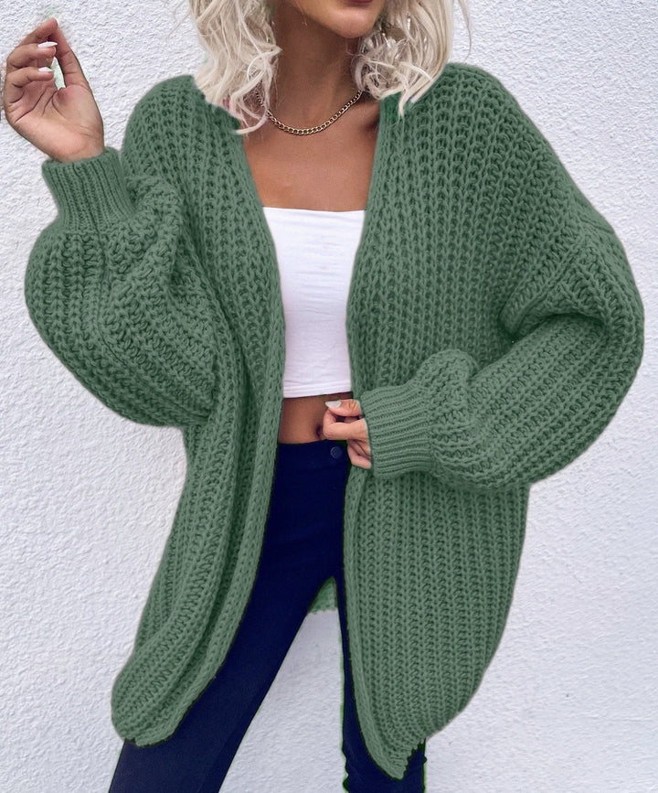 Dam avslappnad grovstickad cardigan med djupa fickor och voluminösa ärmar Eva Jonsson-Eva Jonsson