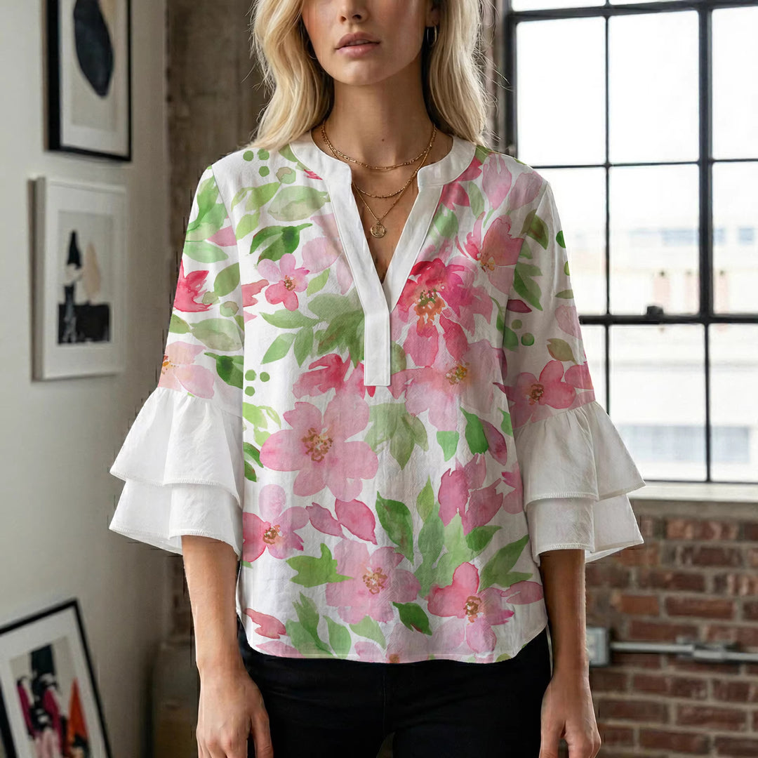 Damblus med voluminösa ryschkarmar och blommigt tryck Mirla-Eva Jonsson