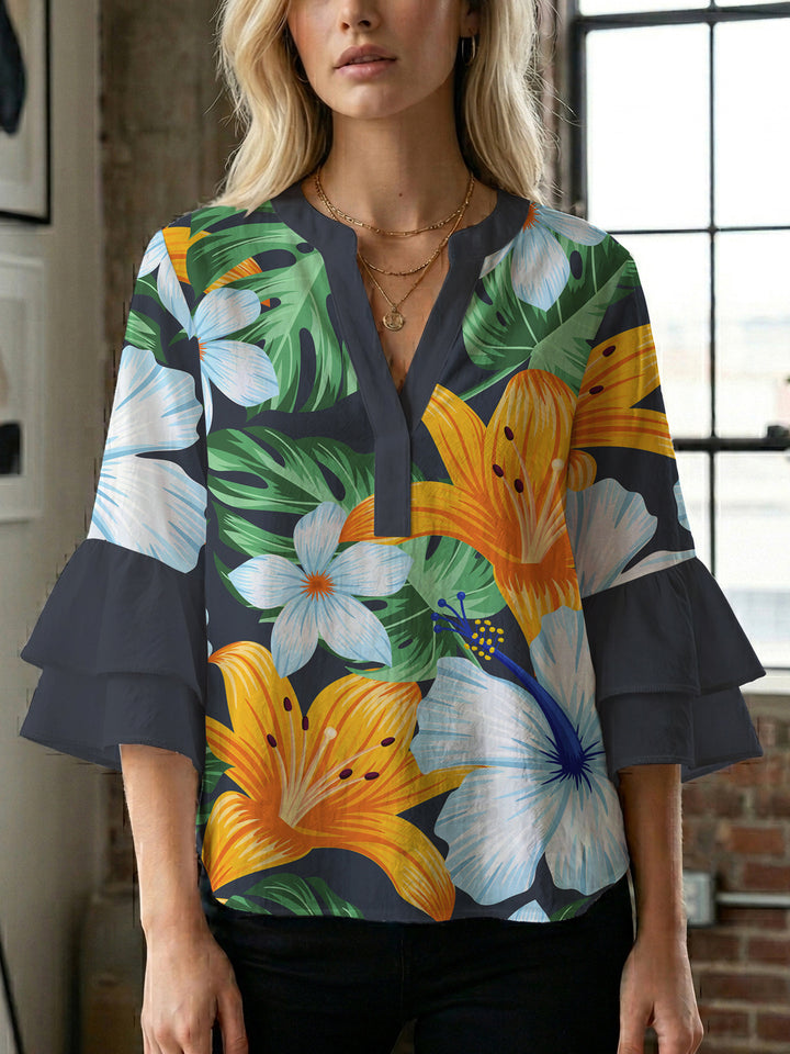 Damblus med voluminösa ryschkarmar och blommigt tryck Mirla-Eva Jonsson