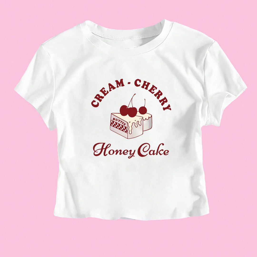 Dame Crop-T-Shirt med kreativ dessertmotiv och modern skärning Mirla-Eva Jonsson