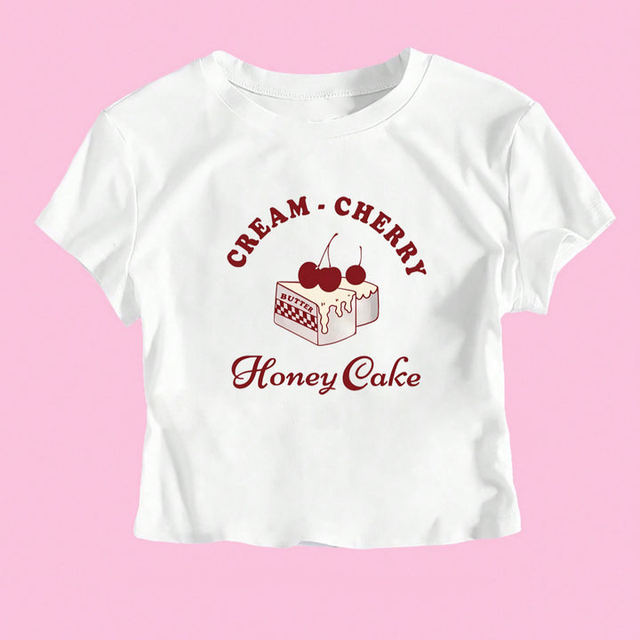 Dame Crop-T-Shirt med kreativ dessertmotiv och modern skärning Mirla-Eva Jonsson