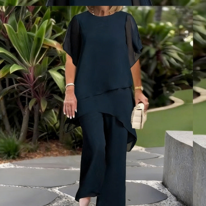 Dame Elegant tvådelad set med luftiga ärmar och asymmetrisk fåll Mirla-Eva Jonsson