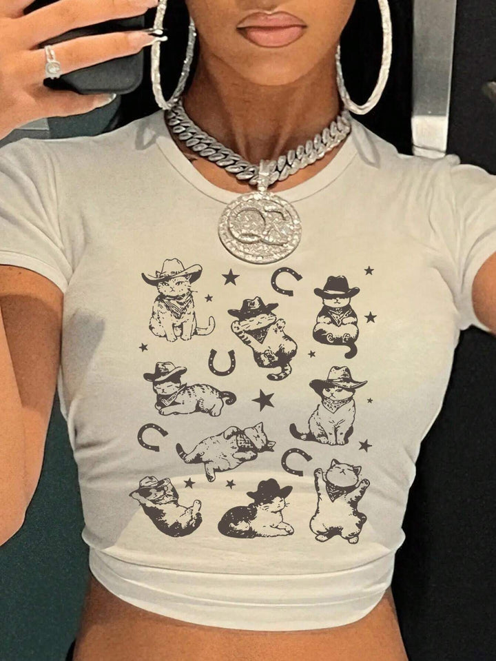 Dame T-shirt med lekfullt kattmotiv och ömma vingar Mirla-Eva Jonsson