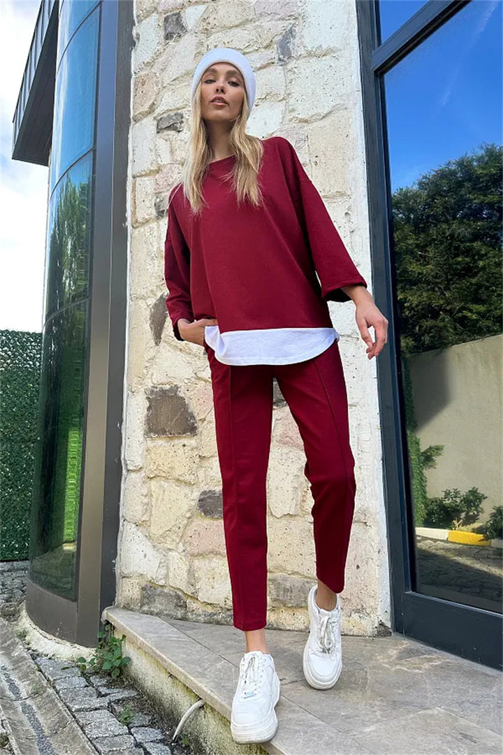 Dame avslappnad sportdräkt med asymmetrisk överdel och figurnuddande byxa Mirla-Eva Jonsson