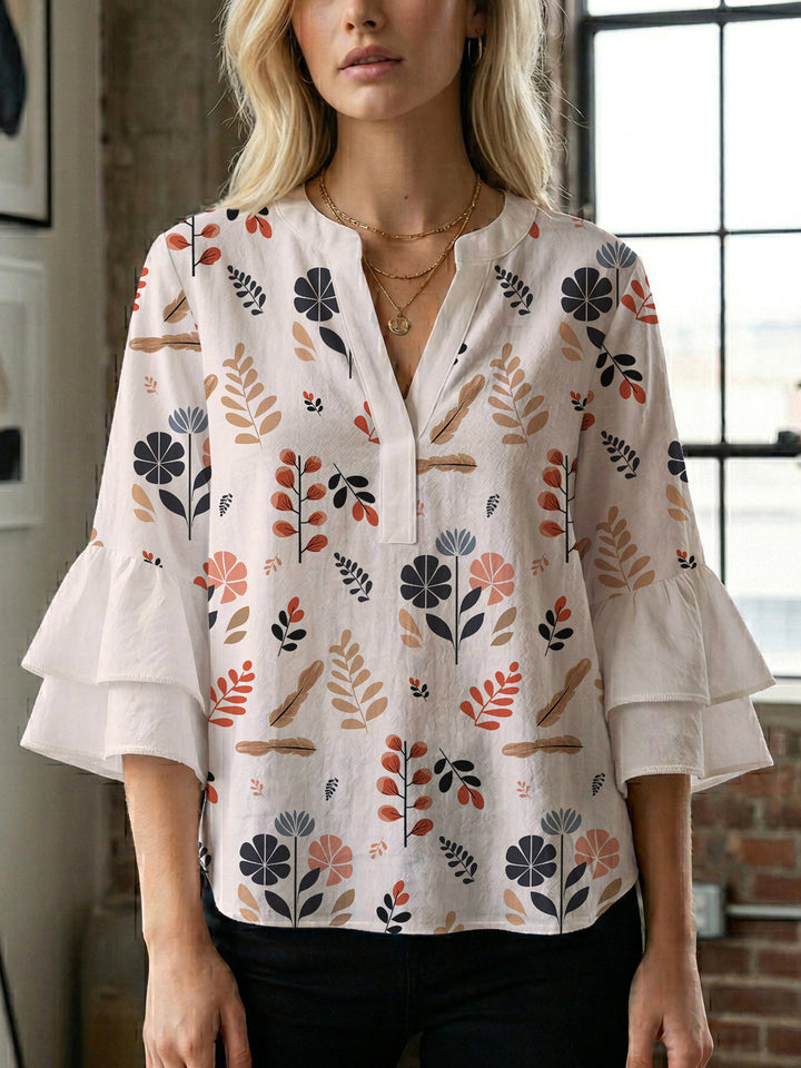 Dame blus med voluminösa volangärmar och modernt motiv Mirla-Eva Jonsson