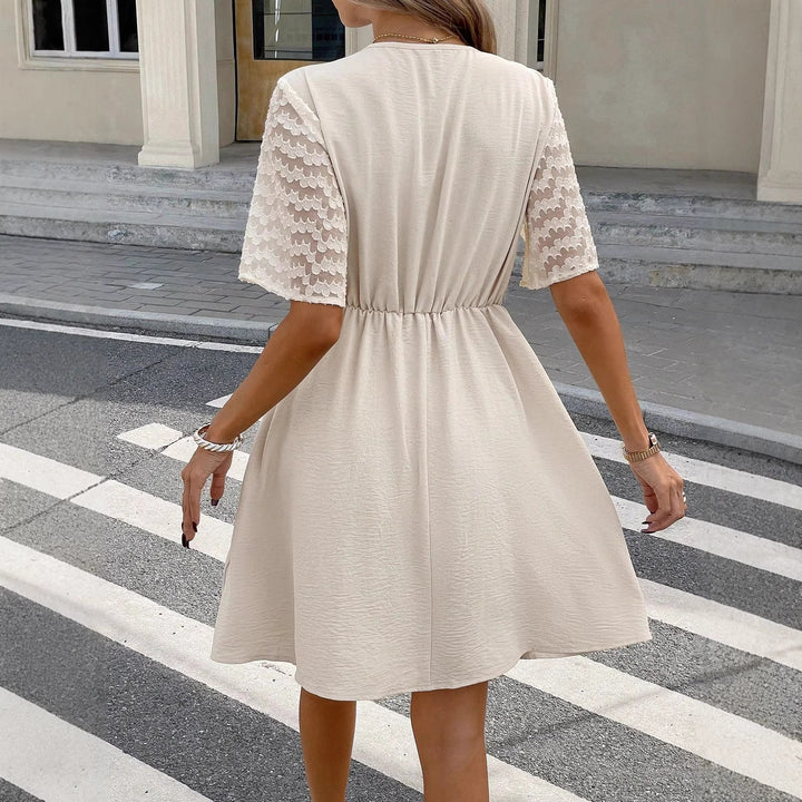 Dame wrap dress with elegant lace sleeves and elastic waist belt Mirla-Eva Jonsson