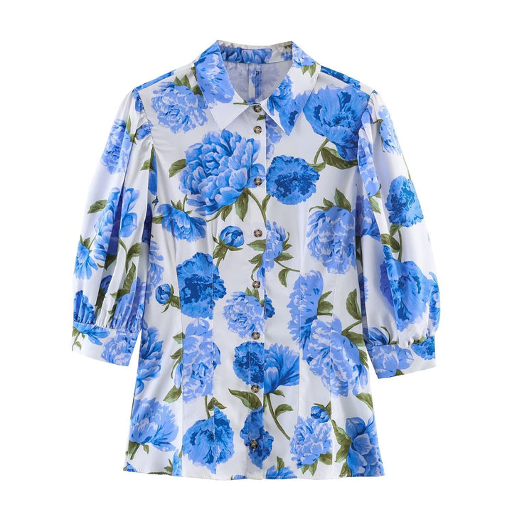 Dameblus med blommönster och eleganta puffärmar Mirla-Eva Jonsson
