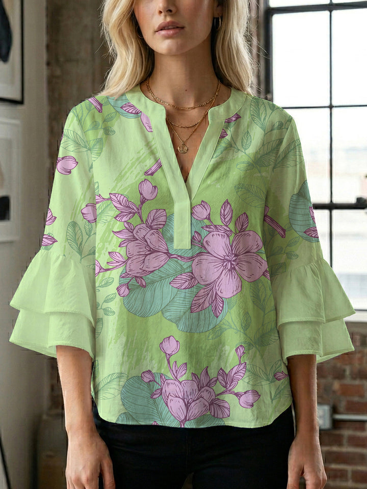 Dameblus med voluminösa ärmar och blommönster Mirla-Eva Jonsson