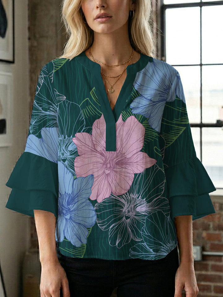Dameblus med voluminösa ärmar och blommönster Mirla-Eva Jonsson