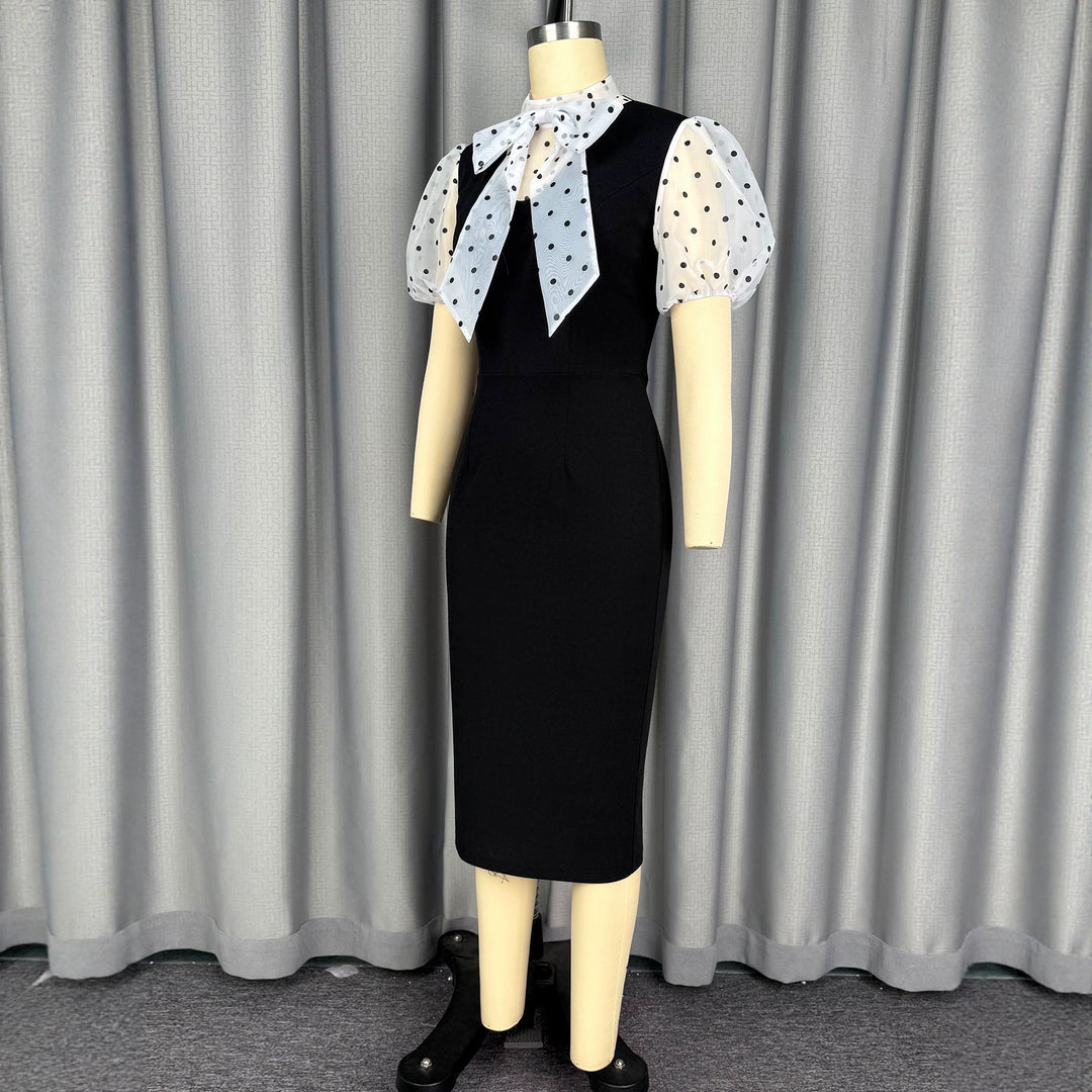 Damens figurnära midi-klänning med transparenta puffärmar och rosettkrage Mirla-Eva Jonsson