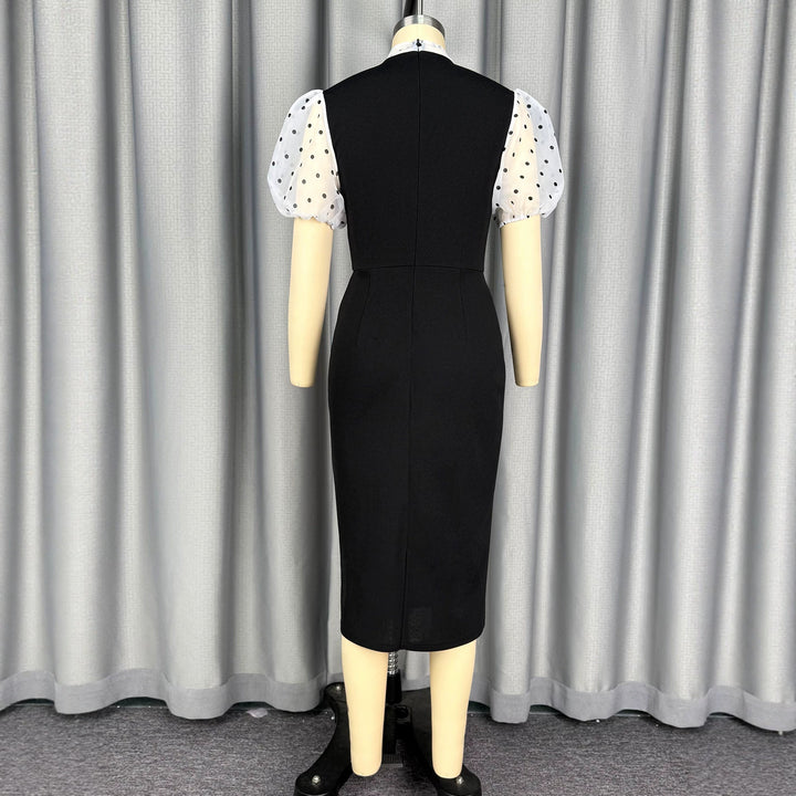 Damens figurnära midi-klänning med transparenta puffärmar och rosettkrage Mirla-Eva Jonsson