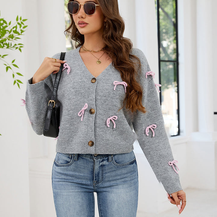 Damens modiga cardigan med lekfulla rosetter Mirla-Eva Jonsson