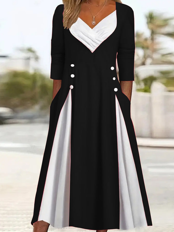 Damer Elegant Midi-klänning med asymmetrisk fåll och stiliga knappdetaljer Mirla-Eva Jonsson