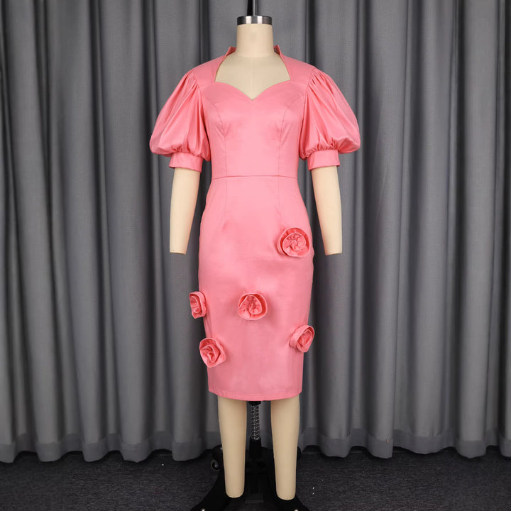 Damer Elegant klänning med voluminösa puffärmar och blommig accent Mirla-Eva Jonsson