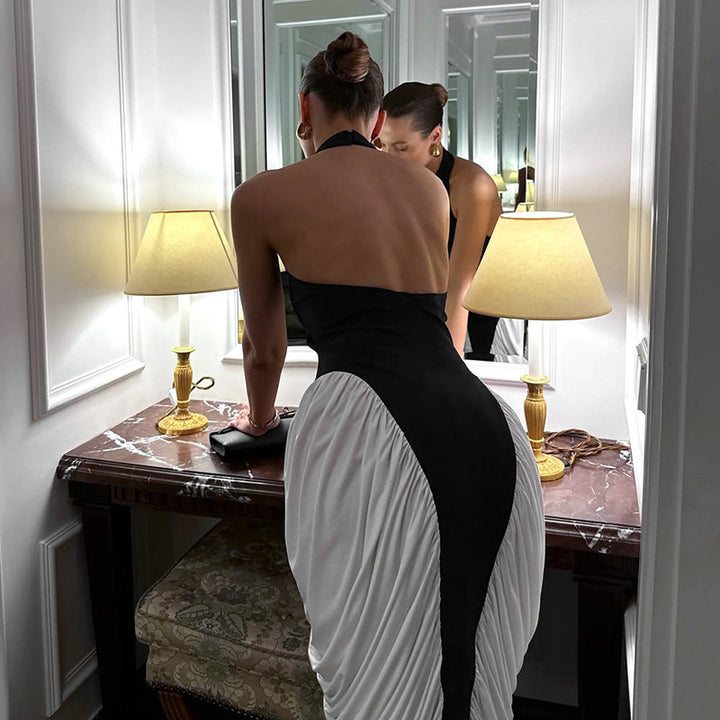 Damer Elegant kvällsklänning med djup ryggöppning och innovativ draperingsdesign Mirla-Eva Jonsson