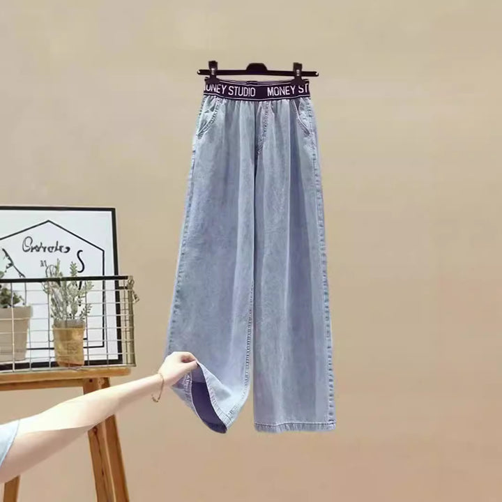 Damer Tvådelat set med lös, randig topp och vida jeansbyxor Mirla-Eva Jonsson