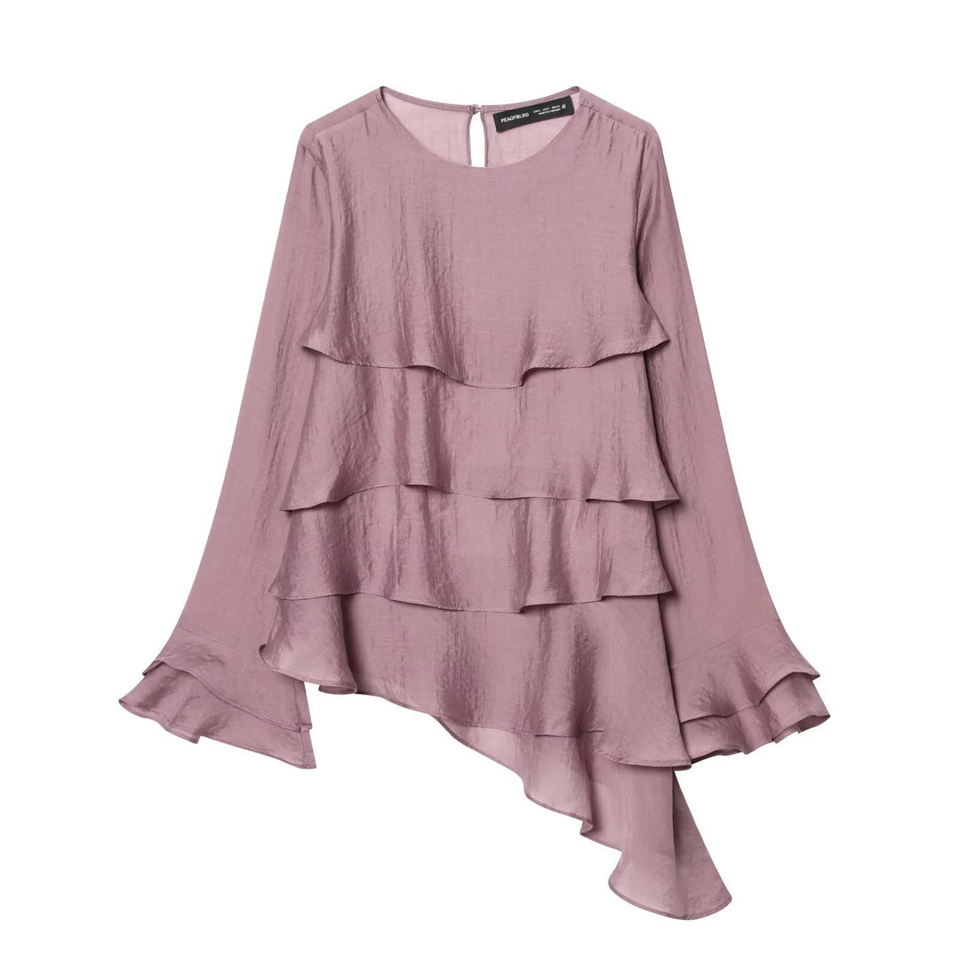 Damer asymmetrisk blus med volangdetaljer och elegant fall Mirla-Eva Jonsson