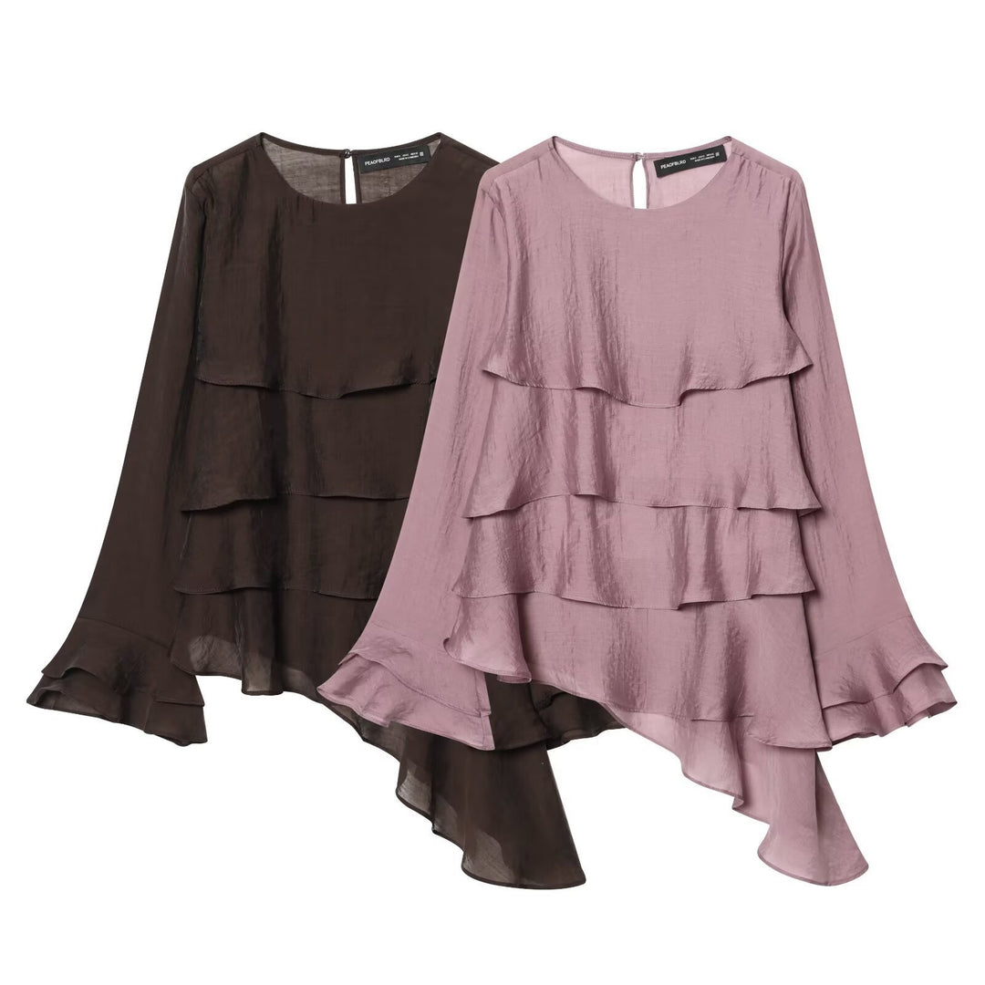 Damer asymmetrisk blus med volangdetaljer och elegant fall Mirla-Eva Jonsson