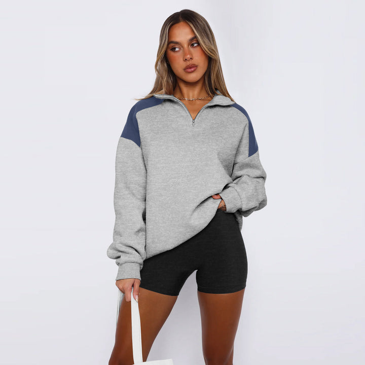 Damer avslappnad sweatshirt med halv dragkedja och kontrasterande ärmar Mirla-Eva Jonsson