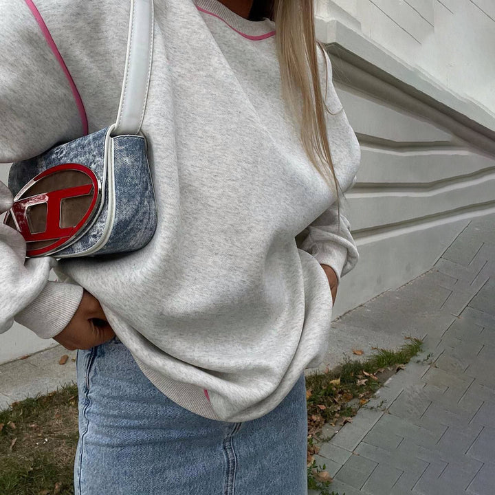 Damer avslappnad sweatshirt med moderna kontraststygn Mirla-Eva Jonsson