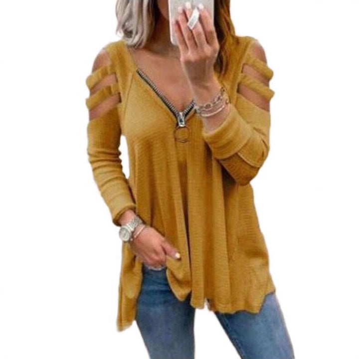 Damer avslappnad topp med trendiga cut-out-detaljer och blixtlås Mirla-Eva Jonsson