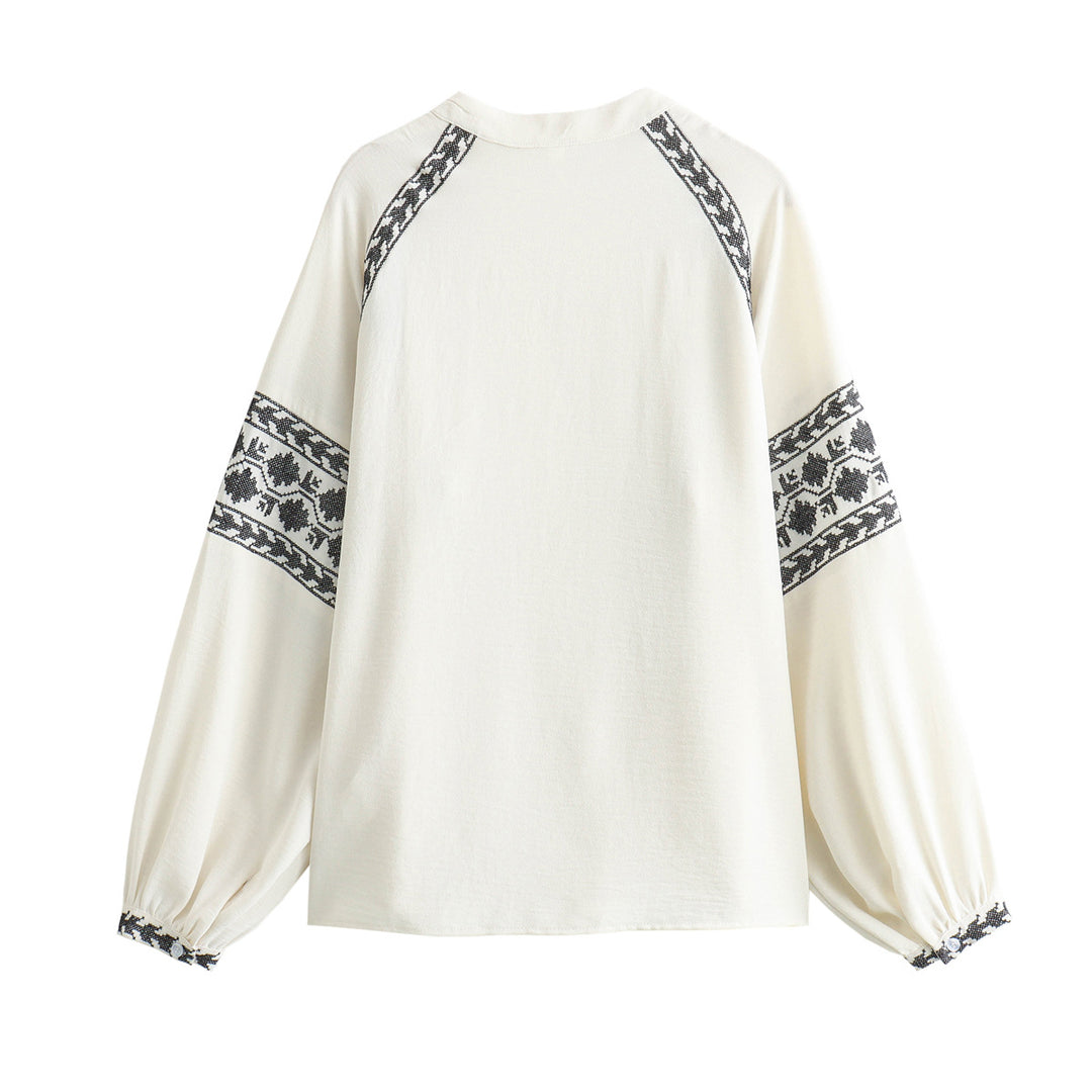 Damer broderad blus med moderna puffärmar och elegant ståkrage Mirla-Eva Jonsson