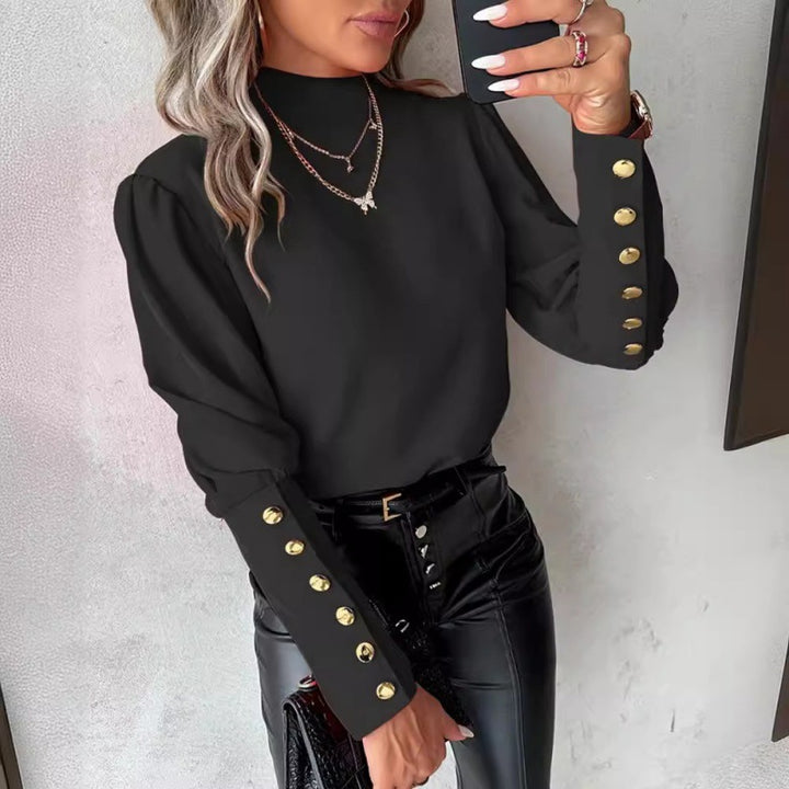 Damer elegant blus med puffärmar och gyllene knappdetaljer Mirla-Eva Jonsson