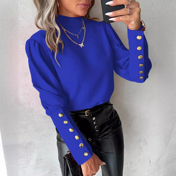 Damer elegant blus med puffärmar och gyllene knappdetaljer Mirla-Eva Jonsson