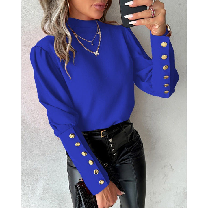 Damer elegant blus med puffärmar och gyllene knappdetaljer Mirla-Eva Jonsson