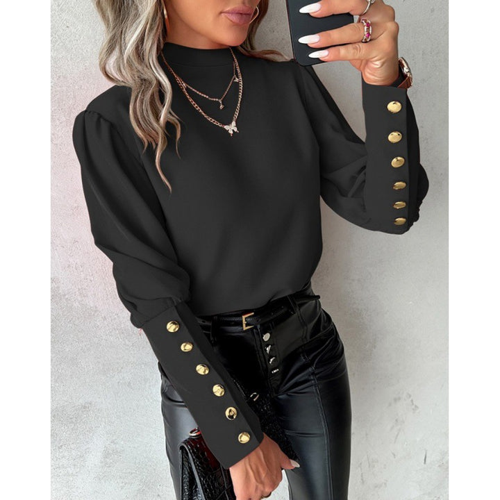 Damer elegant blus med puffärmar och gyllene knappdetaljer Mirla-Eva Jonsson