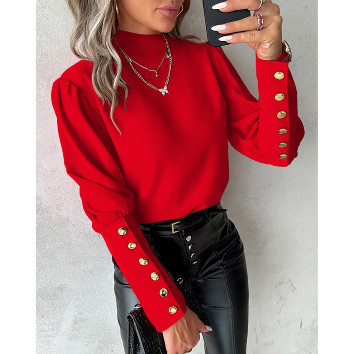Damer elegant blus med puffärmar och gyllene knappdetaljer Mirla-Eva Jonsson