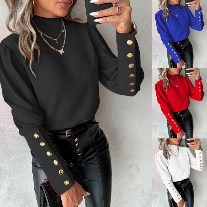 Damer elegant blus med puffärmar och gyllene knappdetaljer Mirla-Eva Jonsson