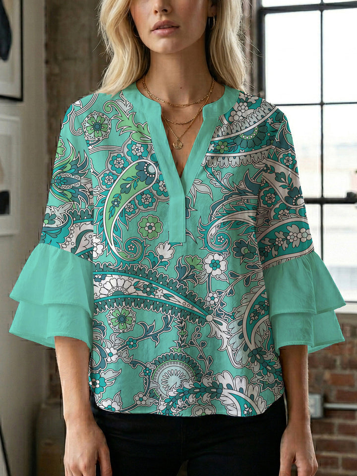 Damer elegant blusenshirt med voluminösa ryschärmar och grafisk blommönster Mirla-Eva Jonsson
