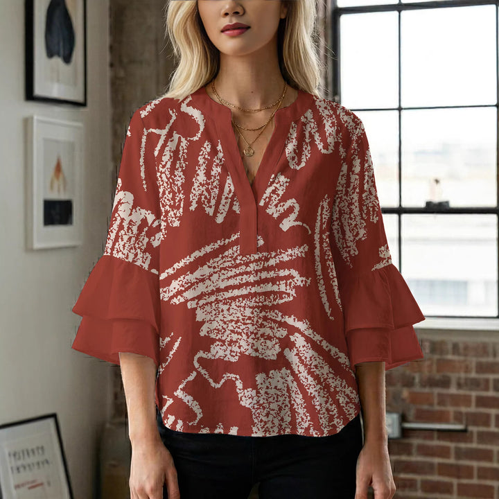 Damer elegant blusenshirt med voluminösa ryschärmar och grafisk blommönster Mirla-Eva Jonsson