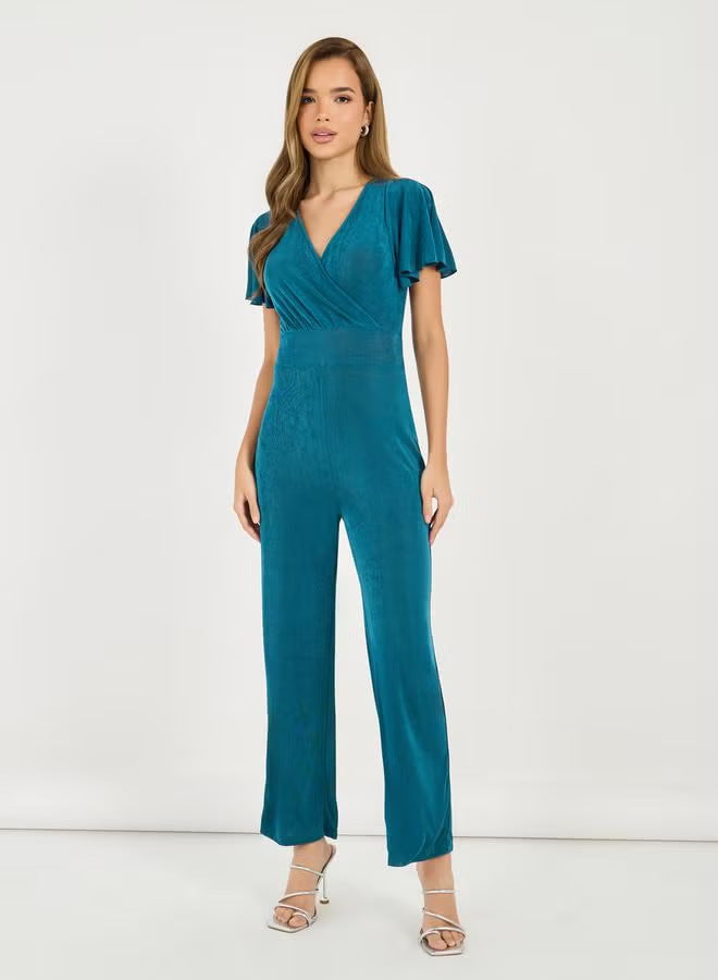 Damer elegant jumpsuit med flödande skärning och detaljrika puffärmar Mirla-Eva Jonsson