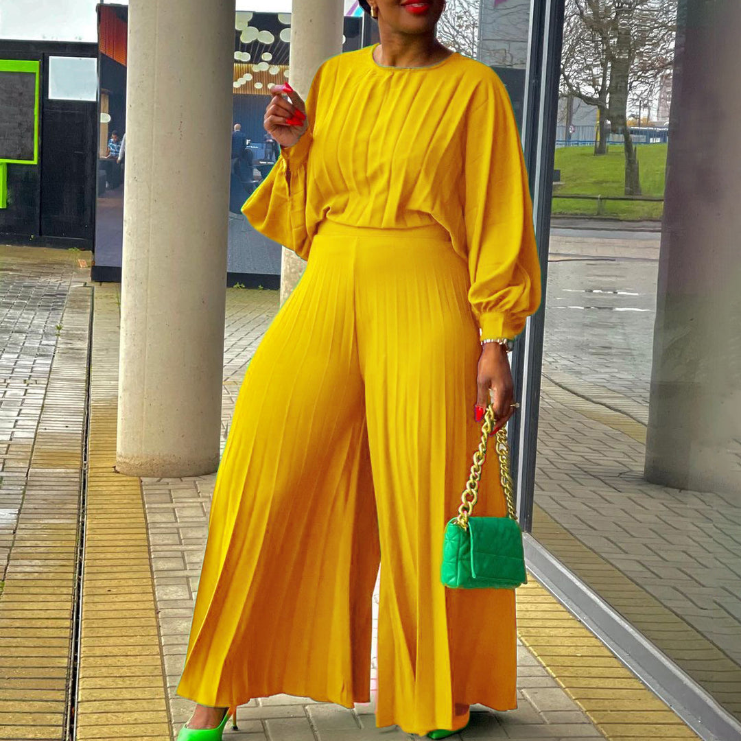 Damer elegant jumpsuit med plissédetaljer och voluminösa ärmar Eva Jonsson-Eva Jonsson