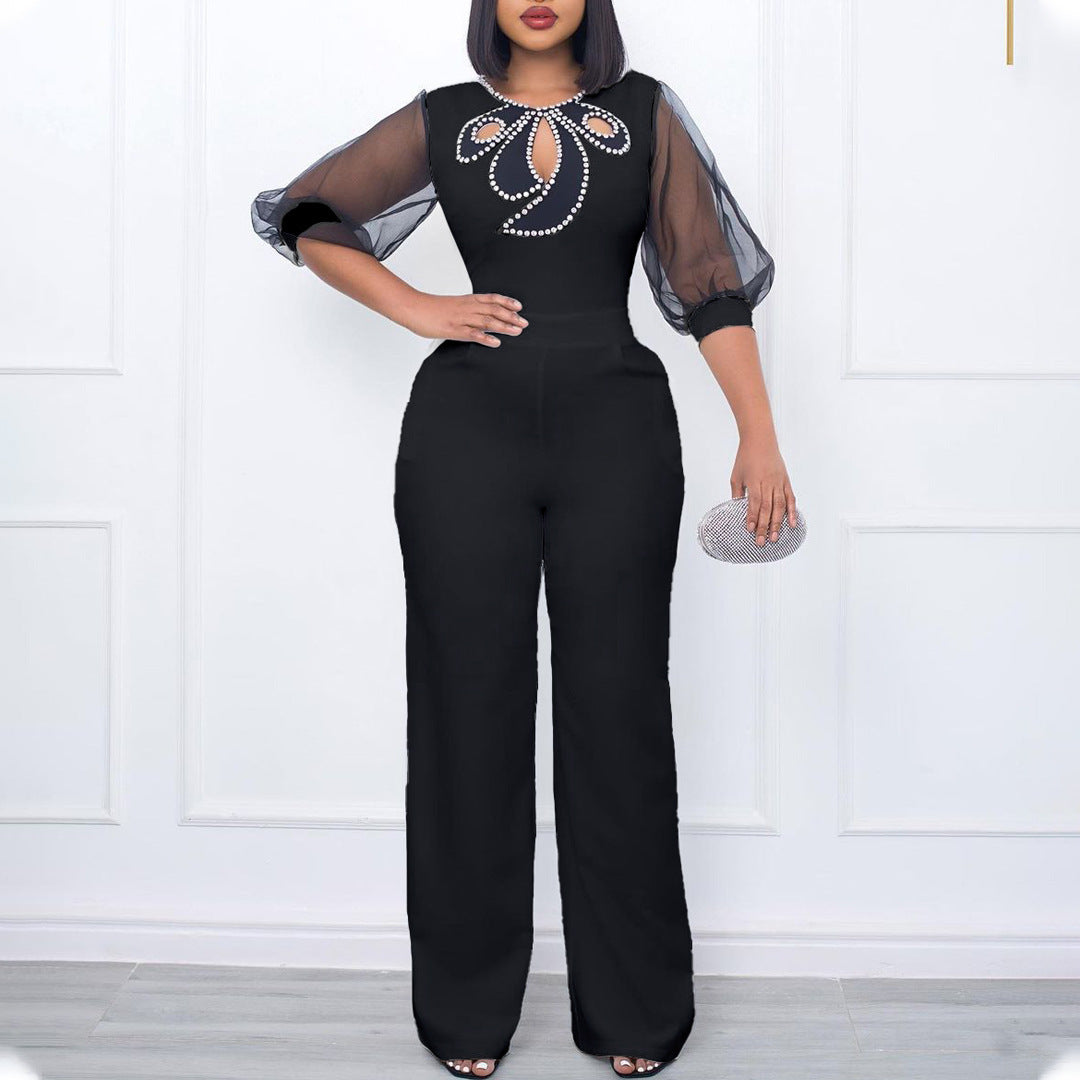 Damer elegant jumpsuit med transparenta puffärmar och skimrande dekorationer Mirla-Eva Jonsson