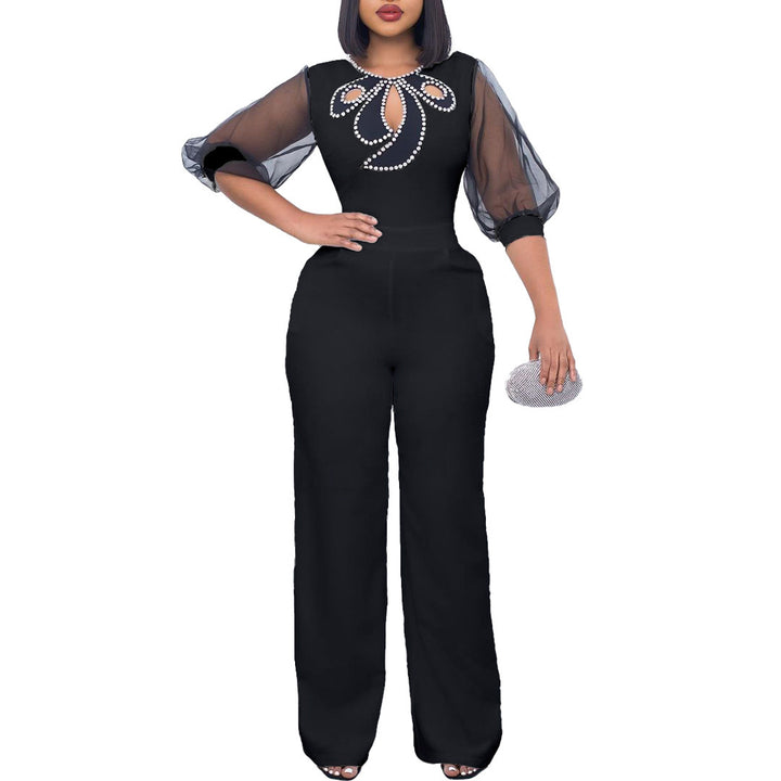 Damer elegant jumpsuit med transparenta puffärmar och skimrande dekorationer Mirla-Eva Jonsson