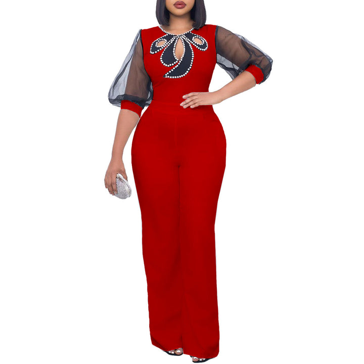 Damer elegant jumpsuit med transparenta puffärmar och skimrande dekorationer Mirla-Eva Jonsson
