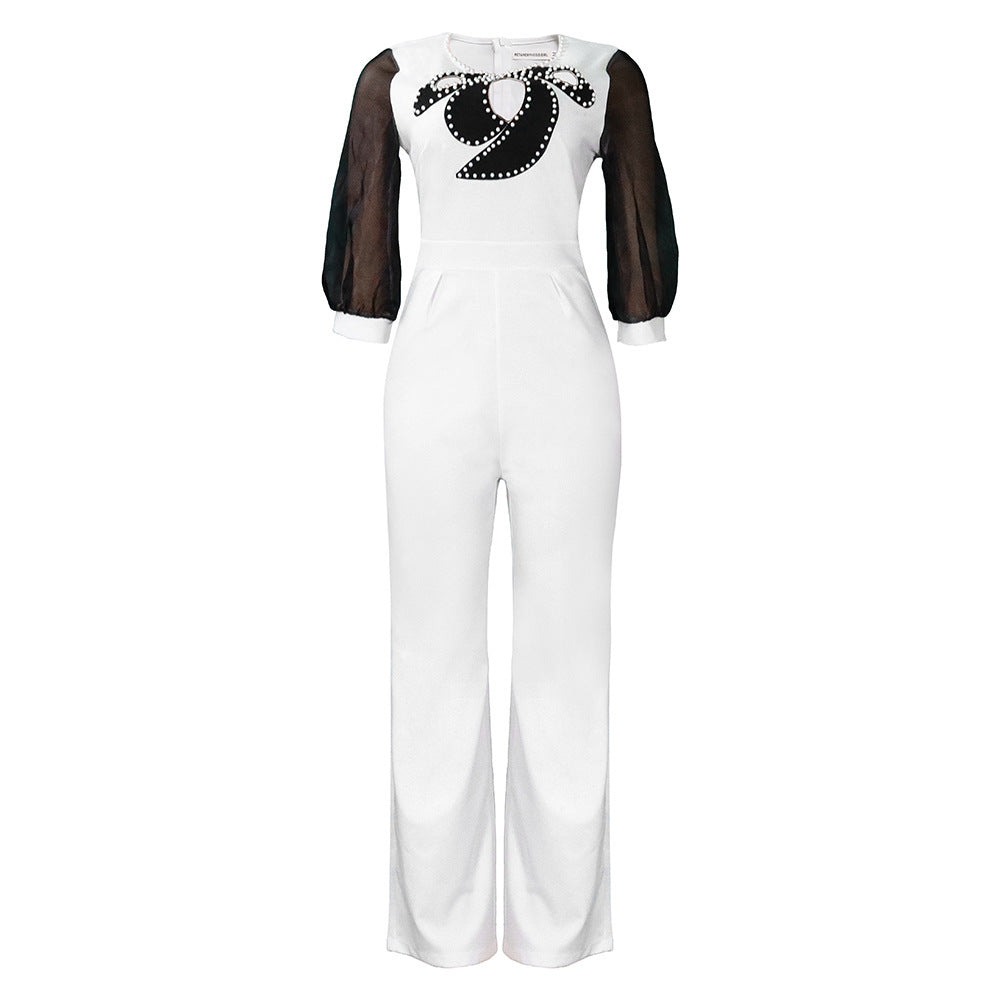 Damer elegant jumpsuit med transparenta puffärmar och skimrande dekorationer Mirla-Eva Jonsson