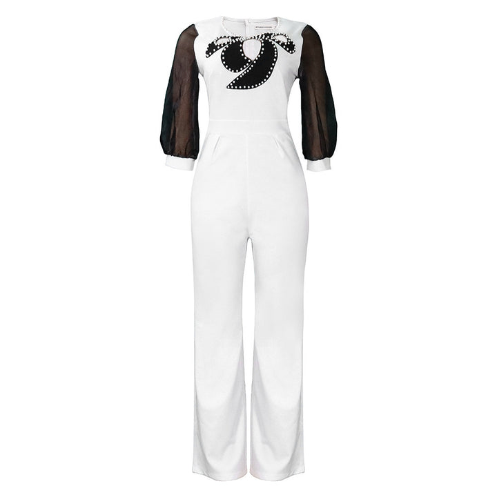 Damer elegant jumpsuit med transparenta puffärmar och skimrande dekorationer Mirla-Eva Jonsson