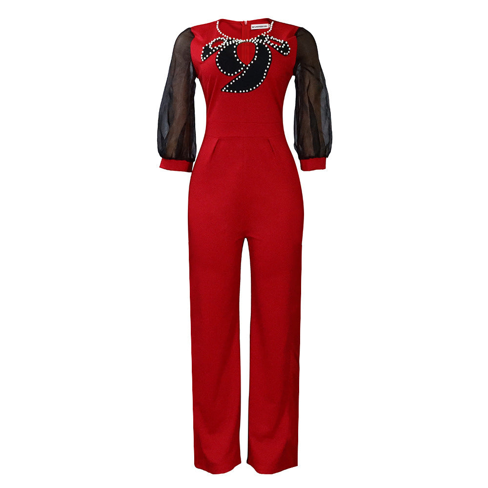 Damer elegant jumpsuit med transparenta puffärmar och skimrande dekorationer Mirla-Eva Jonsson