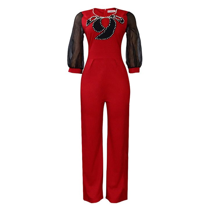 Damer elegant jumpsuit med transparenta puffärmar och skimrande dekorationer Mirla-Eva Jonsson