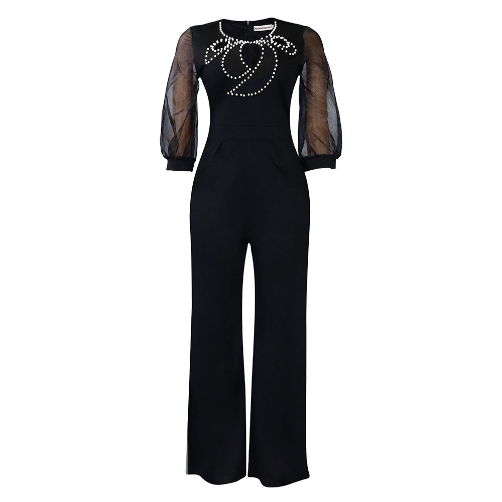 Damer elegant jumpsuit med transparenta puffärmar och skimrande dekorationer Mirla-Eva Jonsson