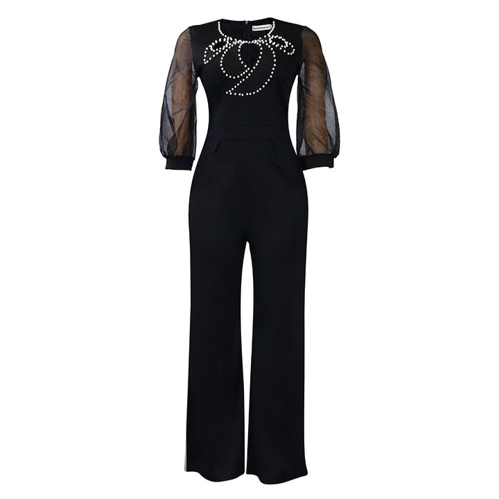 Damer elegant jumpsuit med transparenta puffärmar och skimrande dekorationer Mirla-Eva Jonsson