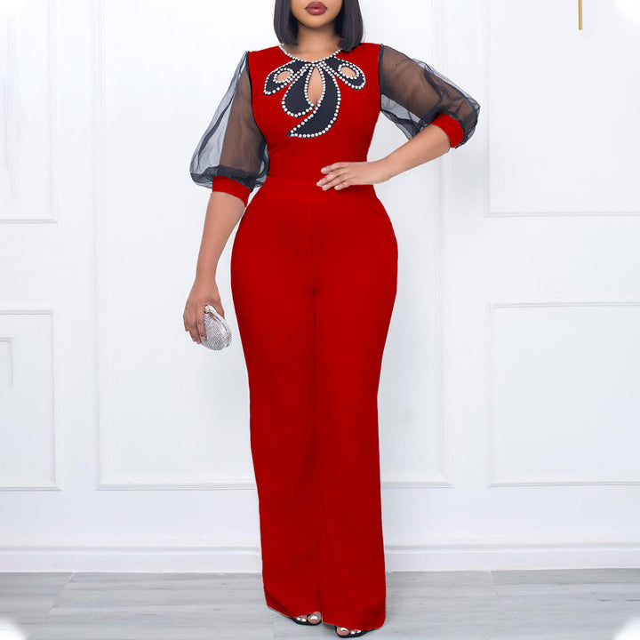 Damer elegant jumpsuit med transparenta puffärmar och skimrande dekorationer Mirla-Eva Jonsson