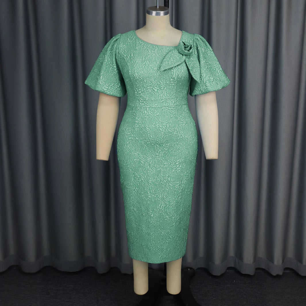 Damer elegant klänning med flödande puffärmar och blomapplikation Mirla-Eva Jonsson